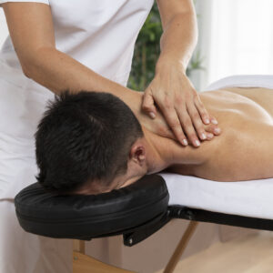 physiotherapist massaging patient office